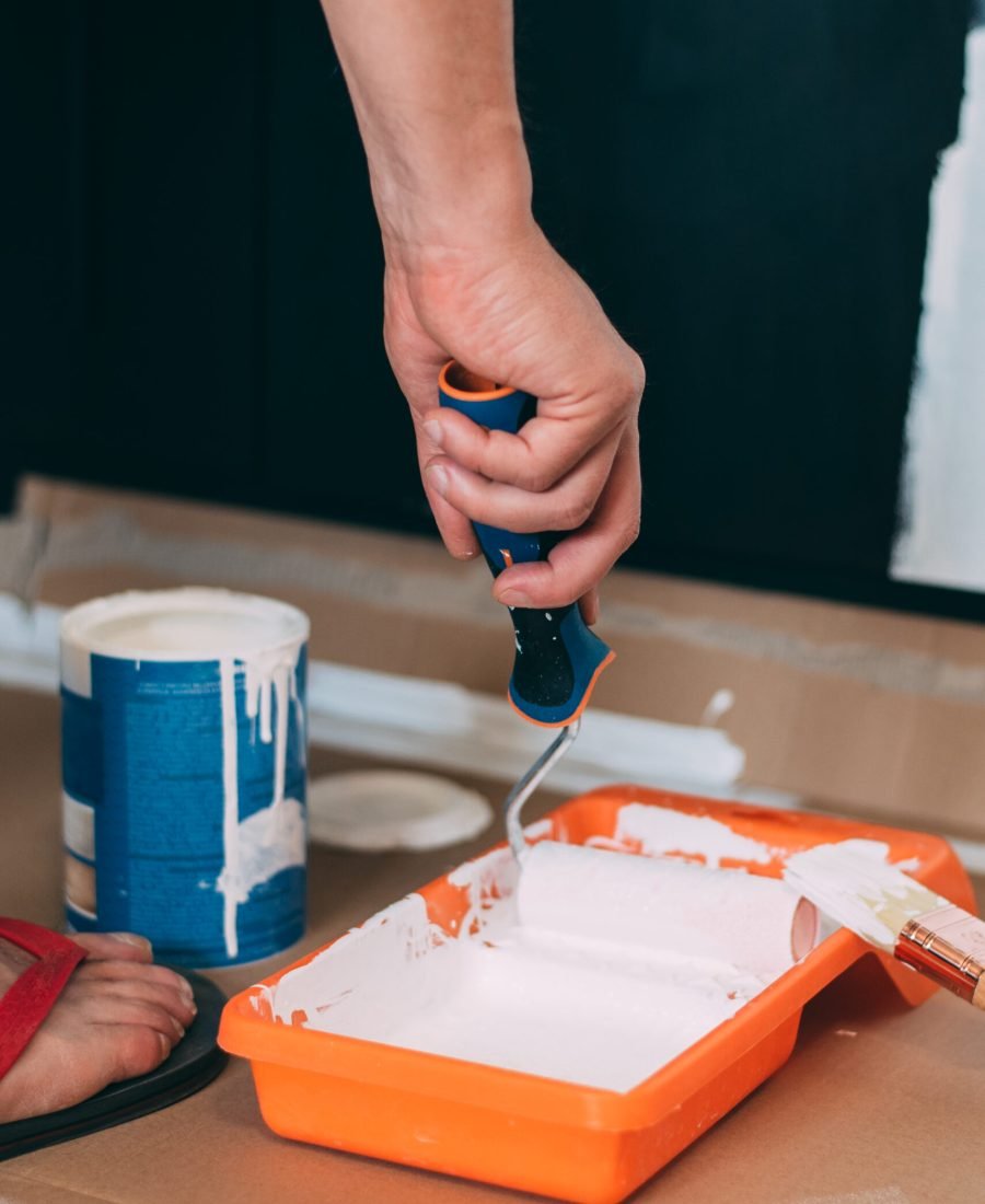 Man hands painting with a roller